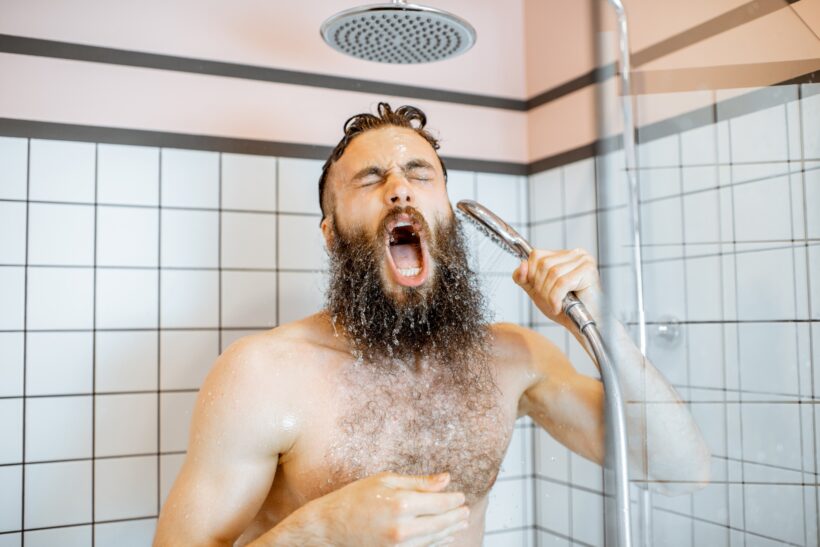 Man takign a shower with cold water